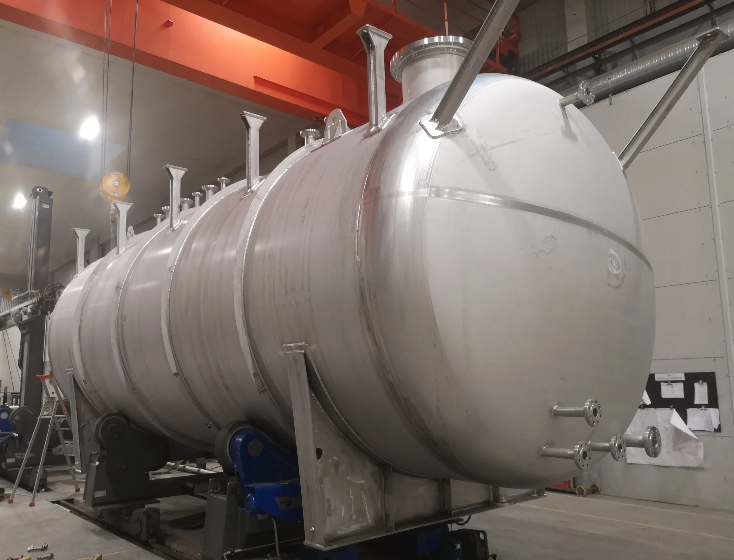 Stainless steel 57 m3 horizontal methanol storage tank rated for 7 barg being fabricated by Western Technological Solutions in a modern seaport workshop in Lithuania