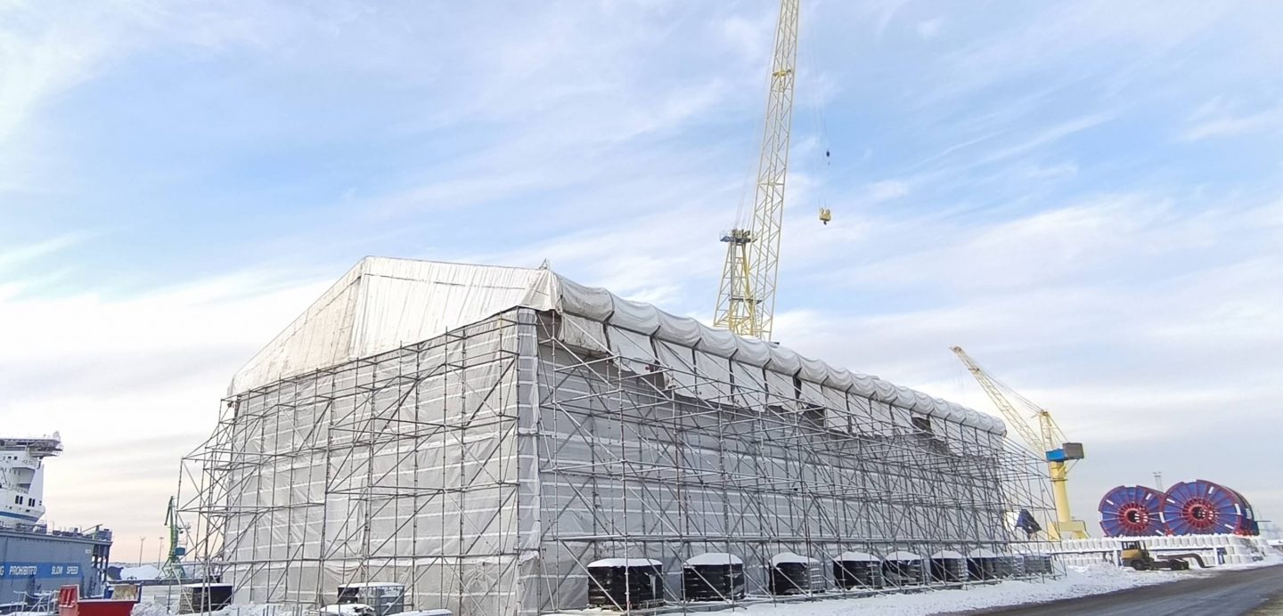 Duplex stainless steel road bridge, 45 m long 240 tons, during final assembly under a temporary weather shelter at a sea-pier load-out area in winter conditions