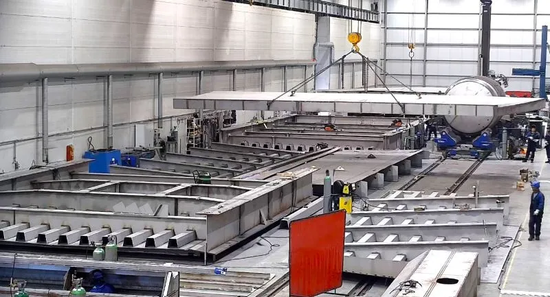 3240m2 large  modern workshop hall located on a sea pier in Klaipeda, designed for stainless‑steel fabrication, welding, and assembly of heavy‑duty structural components and towers