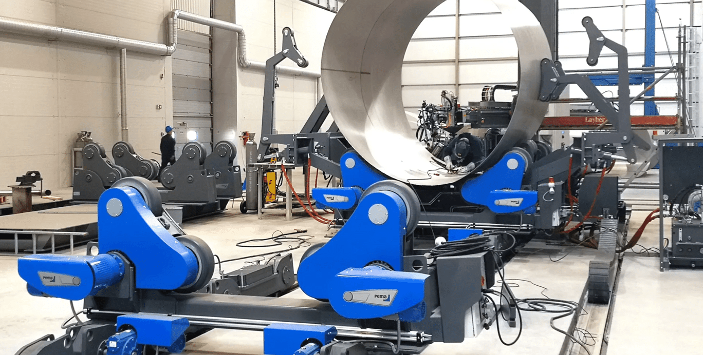Fabrication of a large stainless steel heating buffer tank shell using rolling and welding equipment in a production workshop